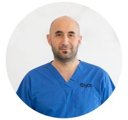 Cryos IVF Clinic 2 Portrait of Christodoulos Christodoulou, MSc in Clinical Embryology, Operations Manager and Senior Embryologist at Cryos IVF Clinic in Cyprus, wearing blue scrubs with clinic logo.